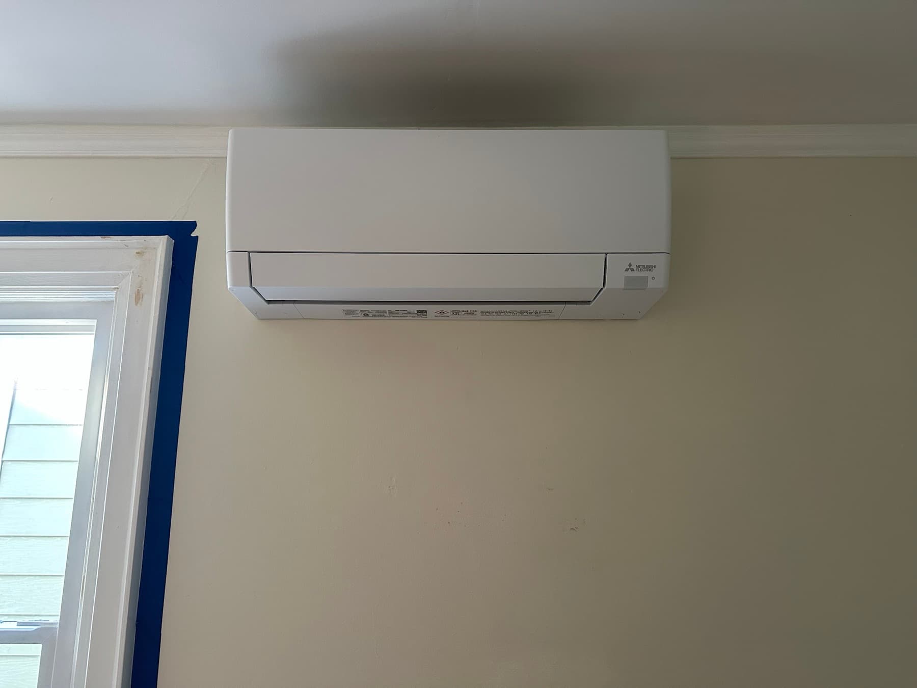 Close view of a Mitsubishi ductless indoor unit installation